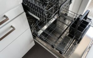 Close up view of an open, empty dishwasher