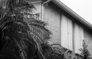 hurricane shutters on a home's second story exterior windows