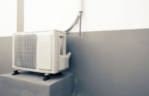 A newer mini-split compressor outside the exterior of a home