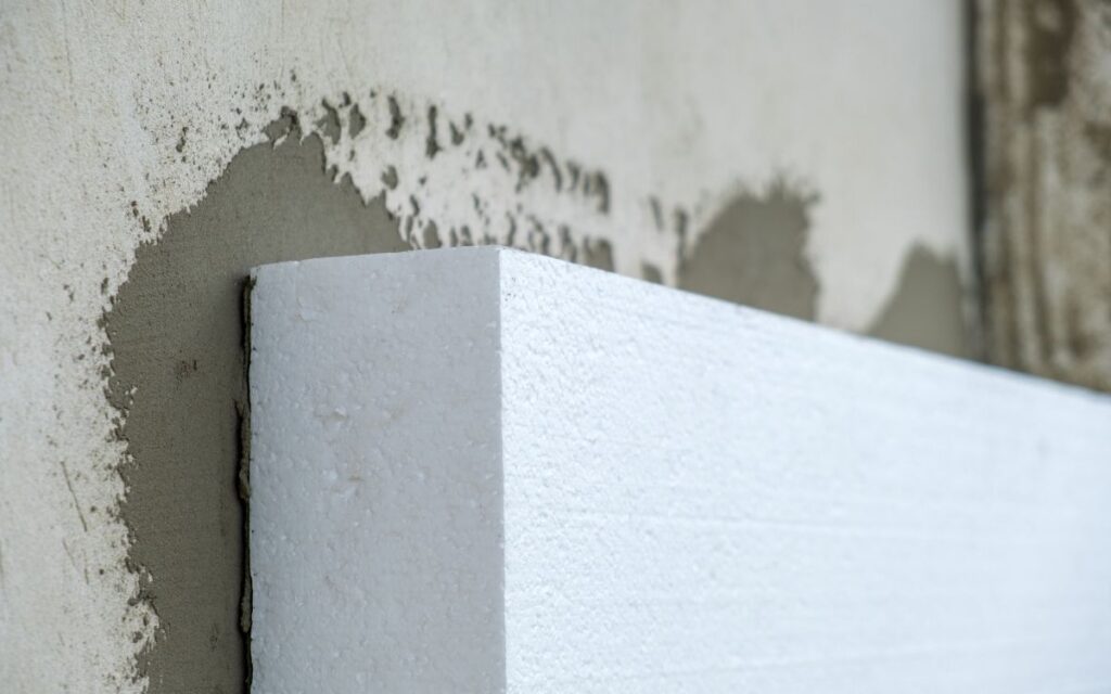 Closeup on the corner of a piece of expanded polystyrene (EPS) cellofoam insulation being installed on a wall