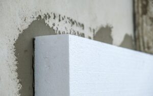 Closeup on the corner of a piece of expanded polystyrene (EPS) cellofoam insulation being installed on a wall