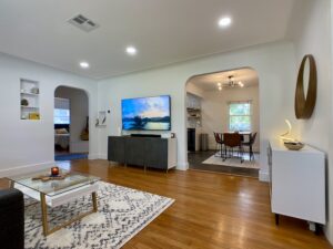 a living room with curved archways and bright ceiling lights on