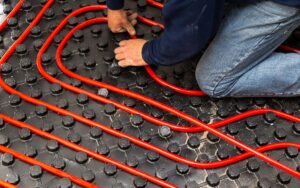 A homeowner installs radiant floor heating in his home