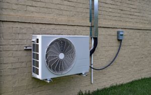 The external compressor unit of a mini-split mounted on home's exterior wall