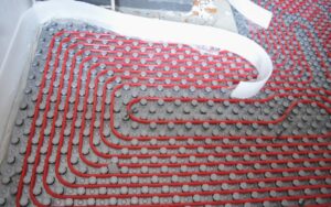 Radiant floor heating tubes are shown on a home's floor during installation