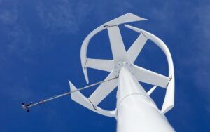 Looking up at a vertical axis small wind turbine's motor from the base of the pole