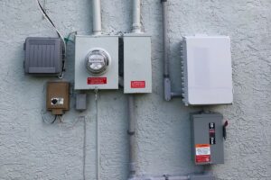A series of electrical connections and cabinets on the outside of an all-electric home.