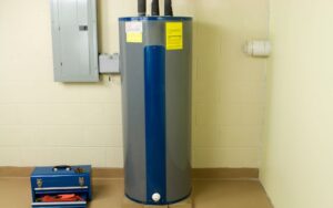 a grey tank water heater in the middle with wiring and plumbing going to it