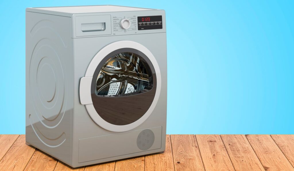 A heat pump dryer in the corner of an eggshell blue-walled room
