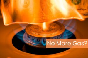 a closeup of a gas stove burner with flames coming up and the words No More Gas? On the right side
