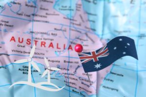 a map of australia with the australian flag on the right, and two wind turbines on the left side