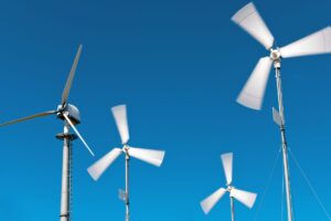 Closeup on the blades and hub of four small wind turbines in motion