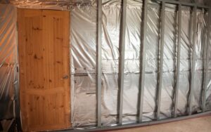 A vapor barrier installed in a wall before the insulation and drywall is added.