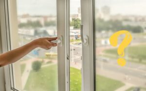 a hand opening a window for ventilation in the room