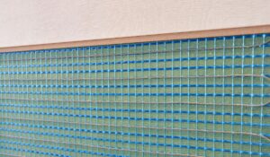 Closeup on an exposed cross-section of a radiant wall heating system