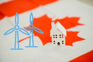 a Canada flag with a little model house and some small wind turbine graphics on top