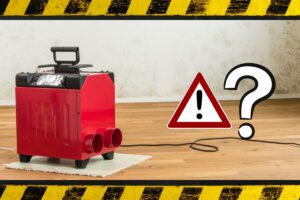 a red dehumidifier on a wood floor with mold on the walls behind it and a caution sign for hazardous material potential
