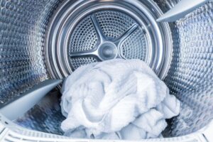 Photo of the interior drum of a heat pump dryer with a lone towel inside
