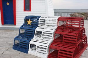 Lobster traps stacked on top of each other, painted and organized as the Acadian flag in New Brunswick, Canada