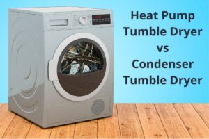 A gray tumble dryer with a large, front-loading door. The dryer sits on a wooden floor with a light blue background. The words, "Heat Pump Tumble Dryer vs Condenser Tumble Dryer" are written in bold black text on the right hand side of the image.