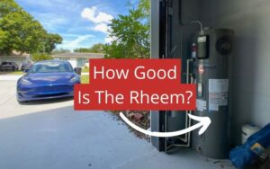 a blue tesla model 3 on the left with a rheem hybrid hot water heater on the grey garage floor on the right