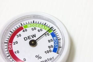 A hygrometer showing moderate home humidity on the dial.