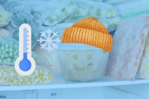 a tupperware bowl in the freezer with a smiley face on it wearing a hat and a thermometer on the left