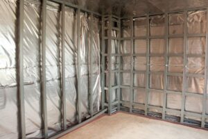A vapor barrier installed in several partially-exposed walls