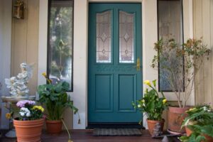 A teal energy-efficient door in the entryway of a home