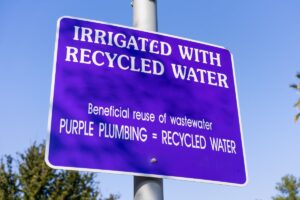 A purple sign noting the use of greywater in irrigation