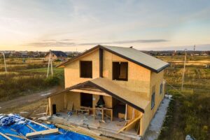 A home using SIP roof panels under construction on a concrete slab foundation