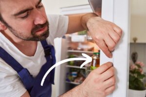 a man installing weather stripping around a door jam in a house