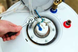 Overview view of a mechanic adjusting a heat pump water heater