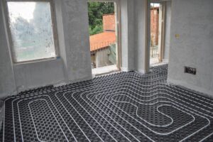 radiant floor cooling tubes installed in an exposed floor