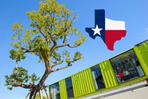 a green shipping container with a tree right next to it, and an outline of texas graphic above the container home