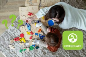 a mom and a boy playing with toys on the living room floor from a top down view with the UL greenguard logo on the right side