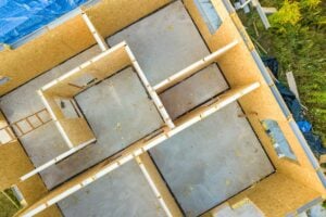 an aerial view of sip construction panels installed on a house foundation with nothing else there yet