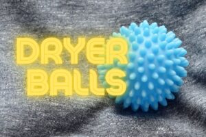 a light blue dryer ball sitting on a grey bedsheet with the words Dryer Balls on the left