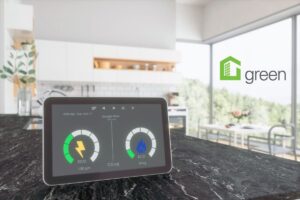 an eco energy monitor sitting on a grey granite countertop of a modern bright energy efficient house with the nar green designation logo at the top right