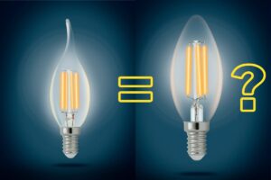 A photo of a glowing e12 bulb at left and an e14 bulb at right