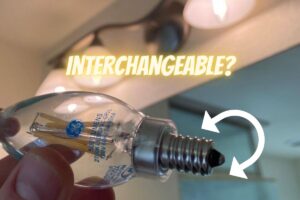 me holding an E12 LED bulb with the words Interchangeable above it