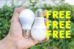 A homeowner's hand holding two energy-saving bulbs, with the text "FREE" transposed repeatedly over the image.