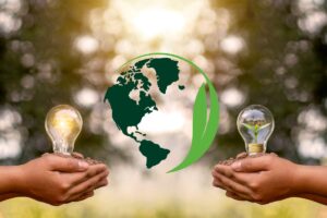 two hands holding light bulbs just outside of an earth graphic with the sun setting in the background