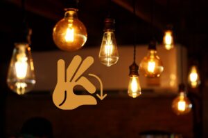 many different lights hanging with a hand graphic indicating a small sign
